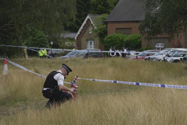 Police officers set up cordon line after a car crashed into a primary school building in Wimbledon, London, Thursday, July 6, 2023. Lo<em></em>ndon police say a girl died when an SUV crashed into an elementary school on a very narrow road in the Wimbledon district of southwest London. The Metropolitan Police said Thursday that there have been further injuries but did not provide details of how many. (AP Photo/Kin Cheung)