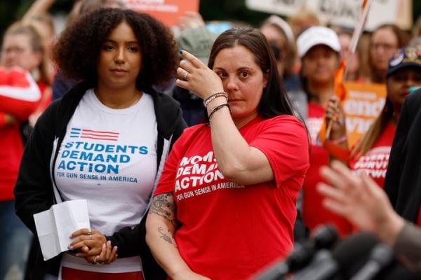 Ade Osadolor (left), a Texas native and a member of the Students Demand Action Natio<em></em>nal Advisory Board, and Erica Leslie Lafferty, whose mother was killed at Sandy Hook Elementary in 2012, attend a rally with fellow Co<em></em>ngressional Democrats and gun co<em></em>ntrol advocacy groups outside the U.S. Capitol on May 26, 2022, in Washington, D.C.