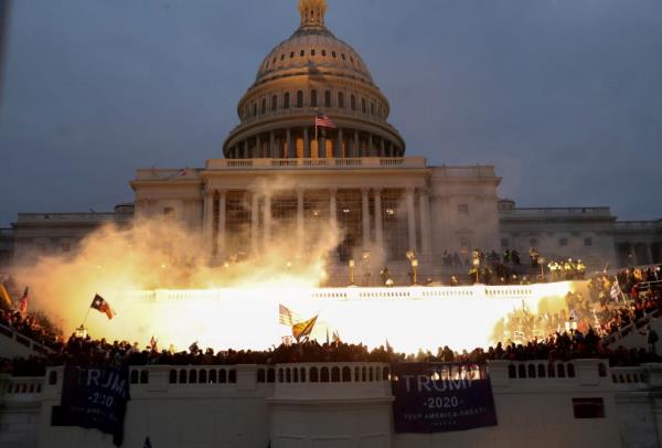 FILE PHOTO: An explosion caused by a police munition is seen while supporters of U.S. President Do<em></em>nald Trump gather in front of the U.S. Capitol Building in Washington, U.S., January 6, 2021. REUTERS/Leah Millis/File Photo<em></em>
Ex-President Do<em></em>nald Trump was called 'the Orange Jesus' on the same day of the January 6 Capitol riot, former Rep Liz Cheney writes